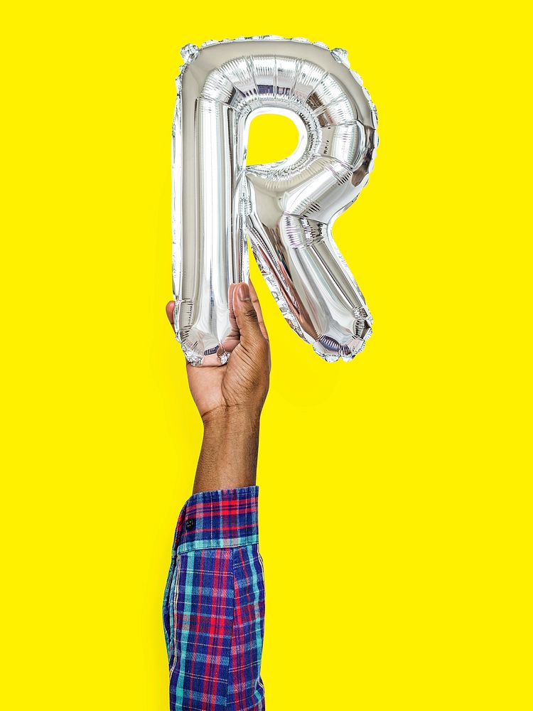 Hand holding balloon letter R