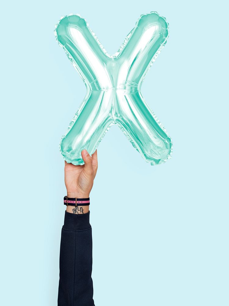 Hand holding balloon letter X