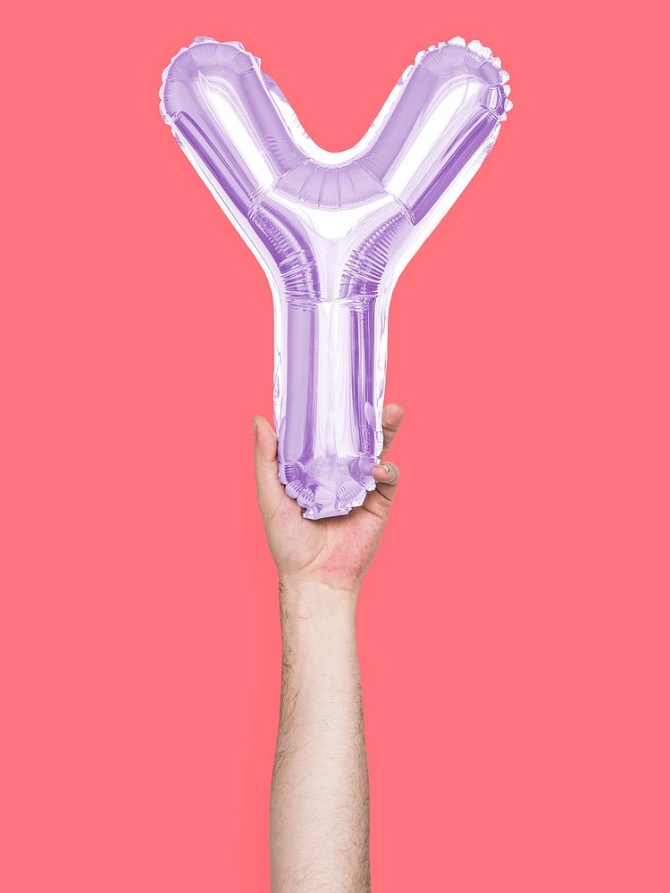 Hand holding balloon letter Y