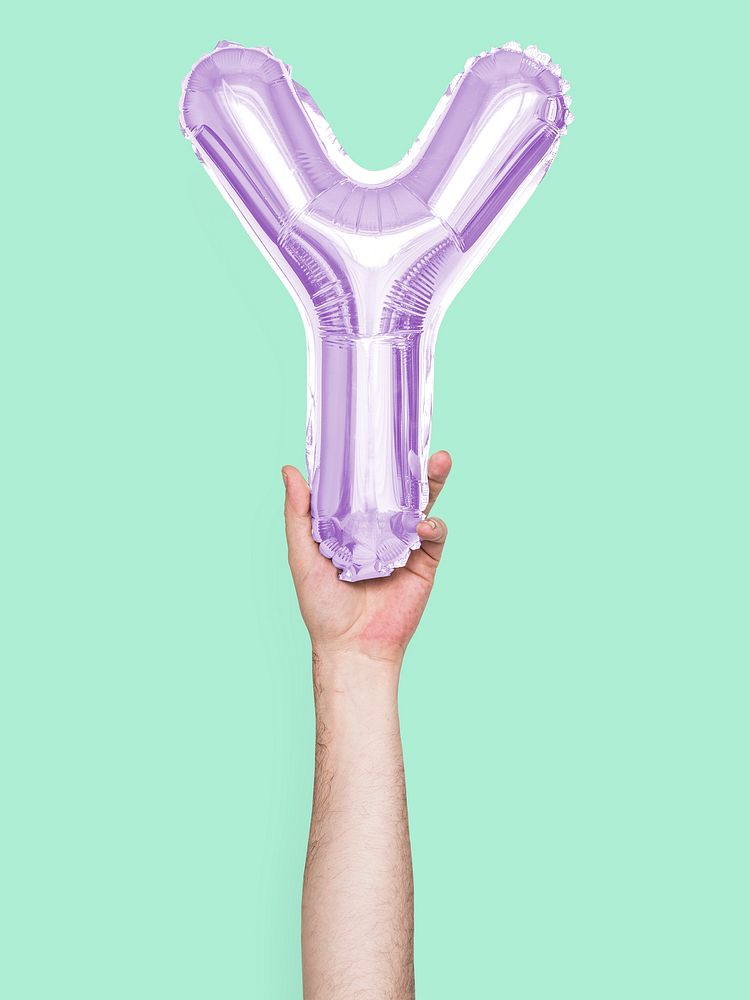 Hand holding balloon letter Y