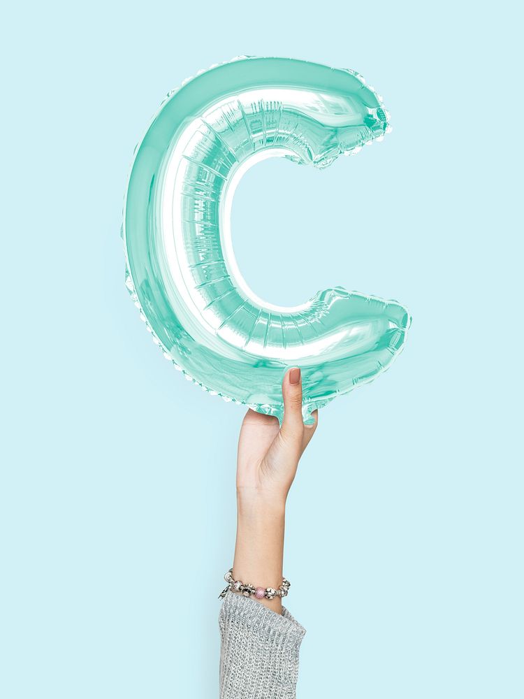 Hand holding balloon letter C