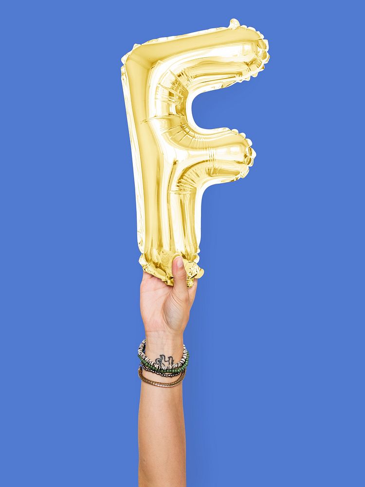 Hand holding balloon letter F