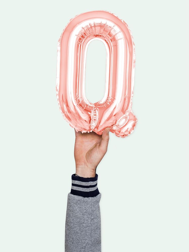 Hand holding balloon letter Q