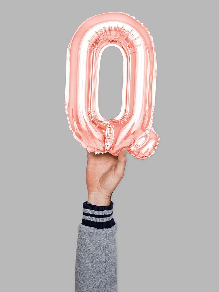 Hand holding balloon letter Q