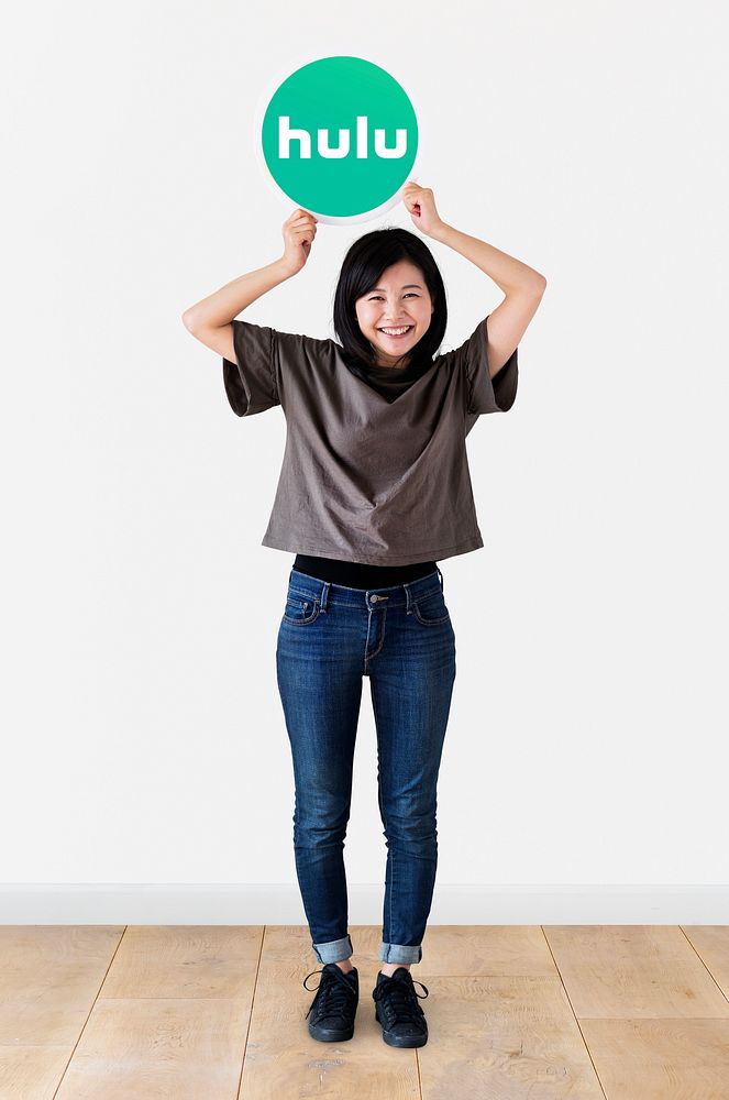 Cheerful woman showing a Hulu icon