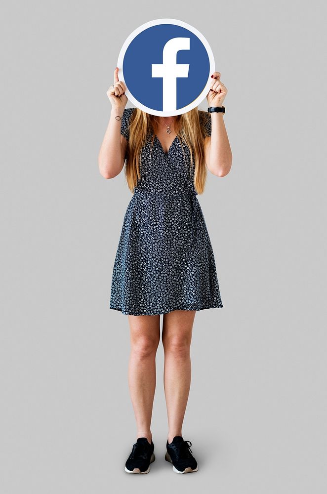 Woman showing a Facebook icon