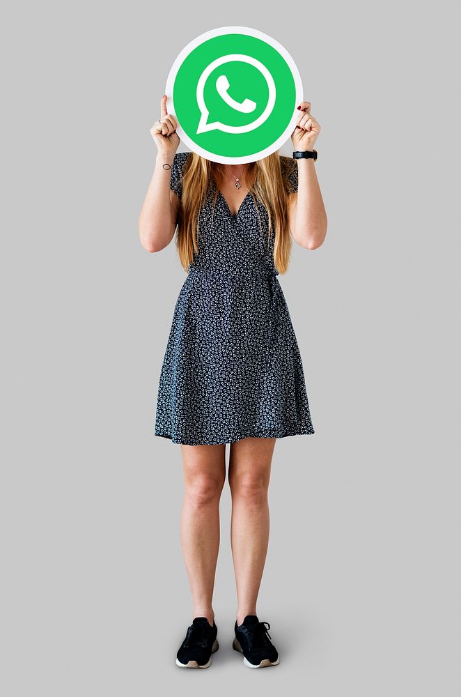 Woman showing a WhatsApp Messenger icon