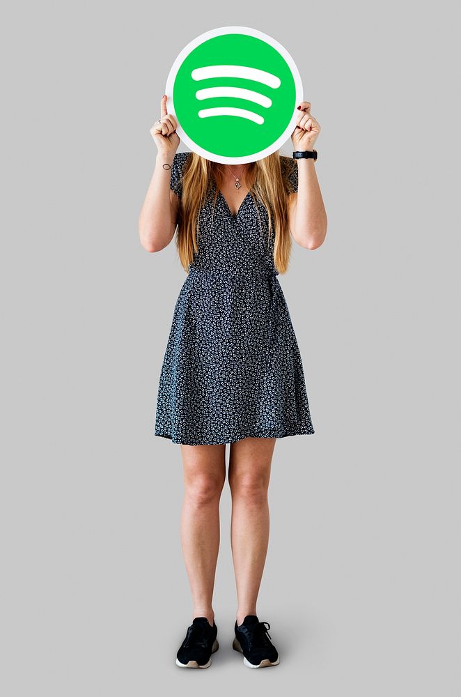 Person holding up a Spotify icon isolated