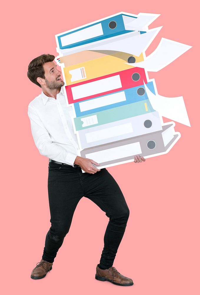Young businessman carrying a stack of binders