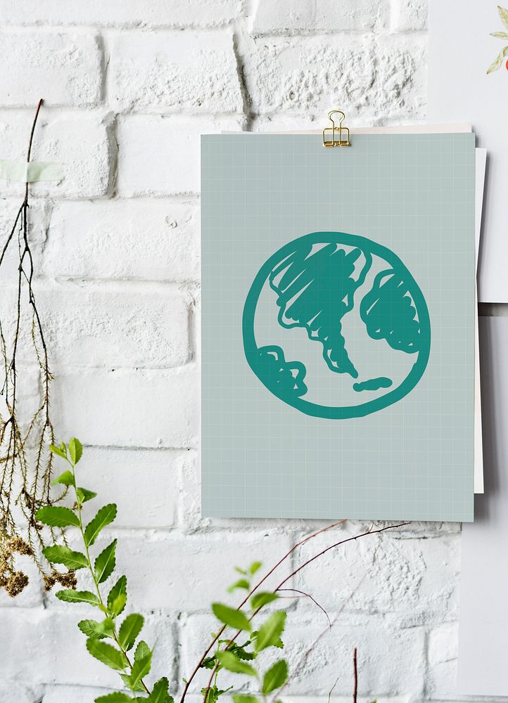 Green globe drawn on a paper poster on white wall