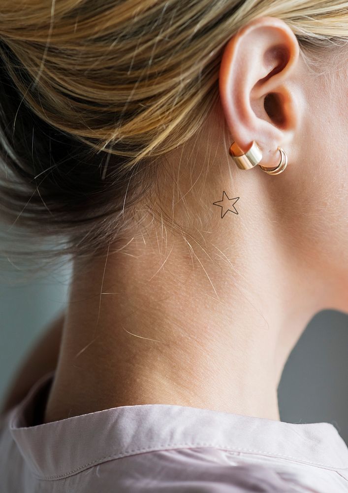 Woman with a star tattoo behind her ear