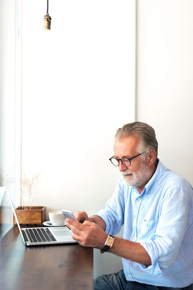 Elderly man is using mobile phone