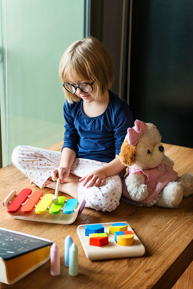 Girl playing with wooden toys