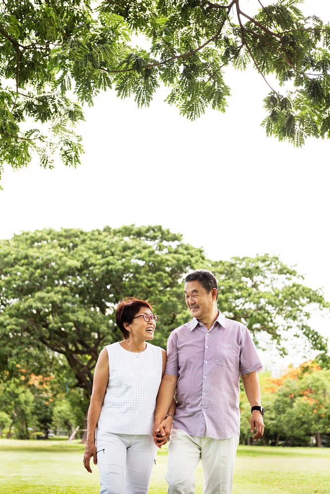 Senior Asian Couple Walking Park Concept