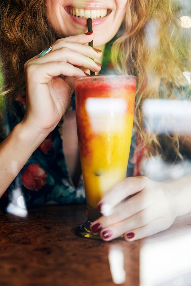 Woman with a colorful drink