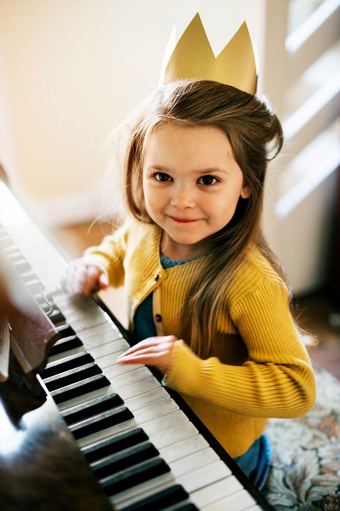 Little girl playing a piano