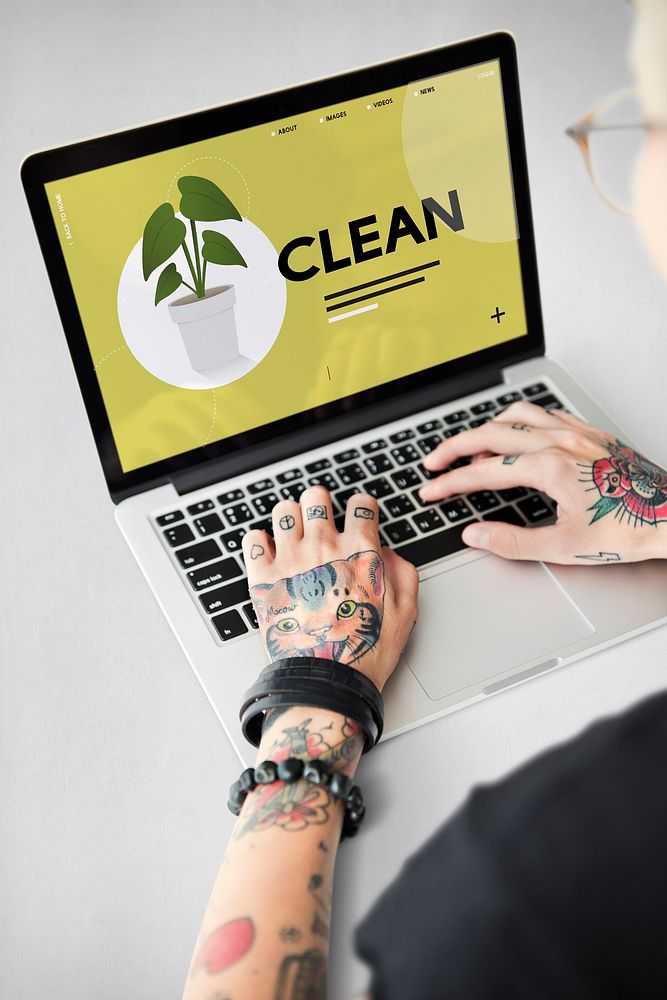 Tattooed hands going green on laptop