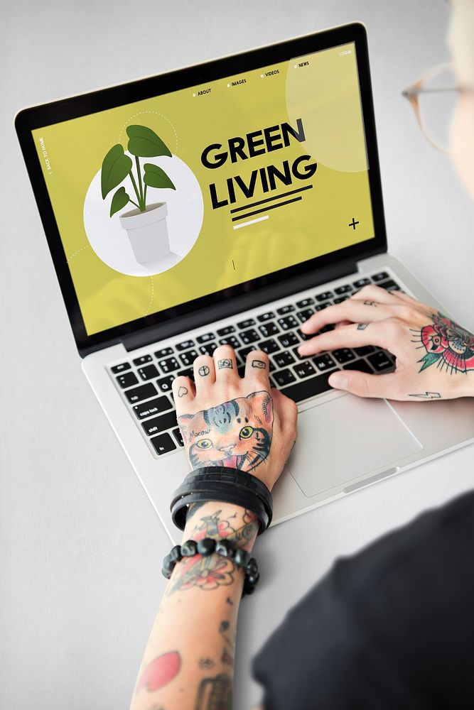 Tattooed hands going green on laptop