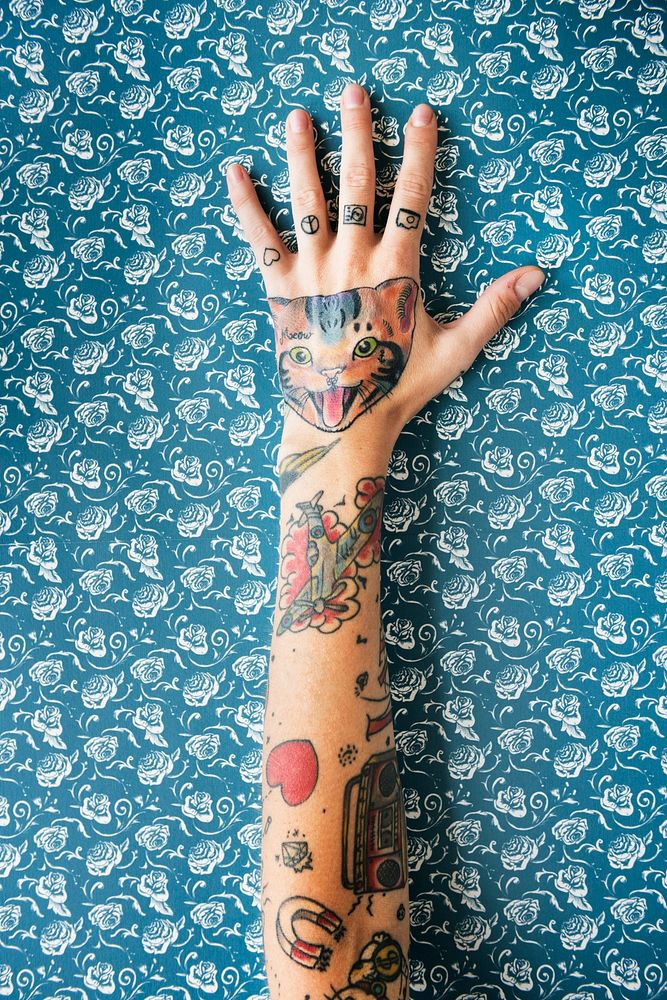 Tattooed hand on blue background