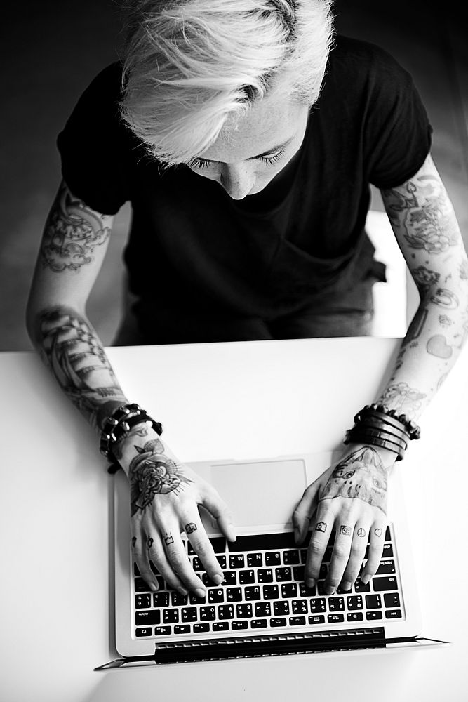 Tattooed woman using a laptop