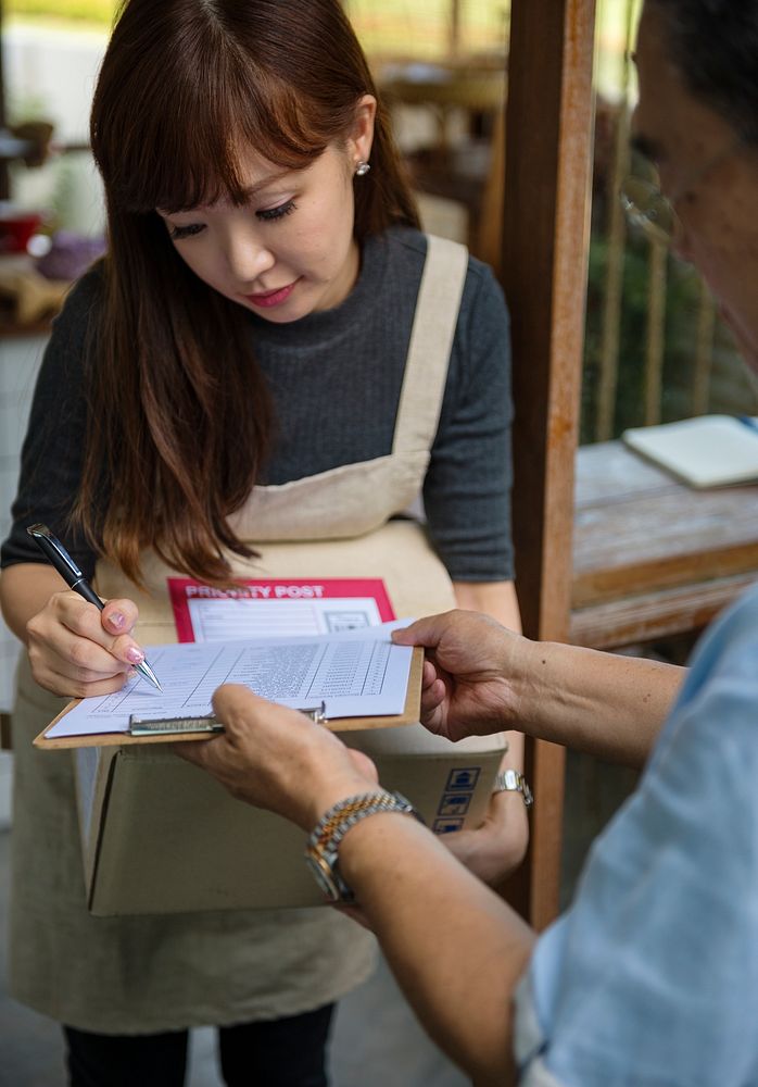 Woman signing for a delivery package