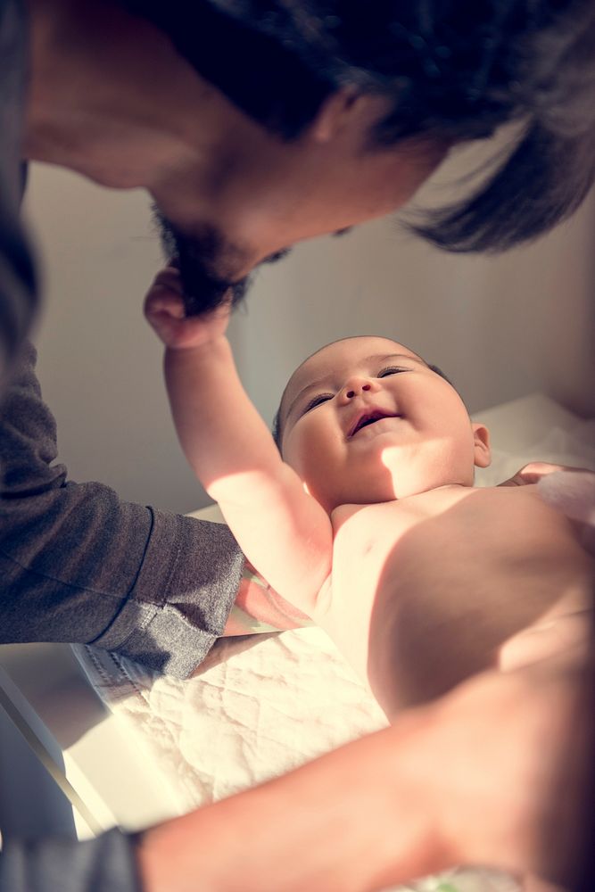 Cute Baby Newborn Playing with Daddy Smiling