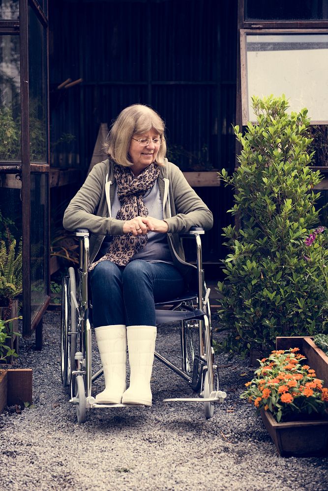 Senior Adult Woman Sitting on Wheelchair in a Park