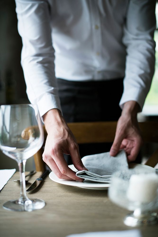 Restaurant Staff Setting Table in Restaurant for Reception