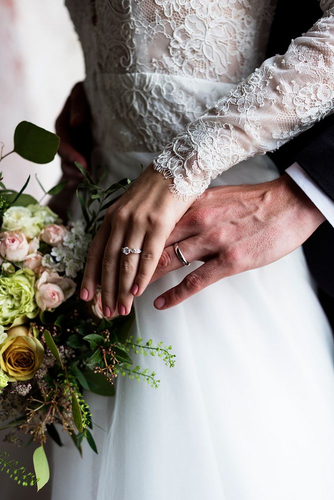 Newlyweds' hands wearing their wedding rings