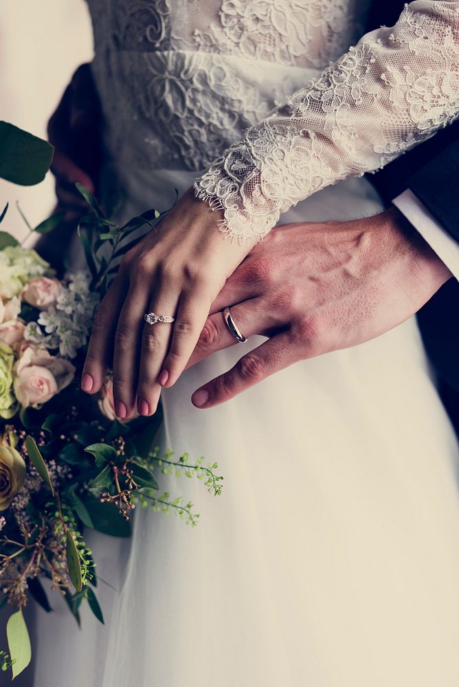 Newlyweds' hands wearing their wedding rings