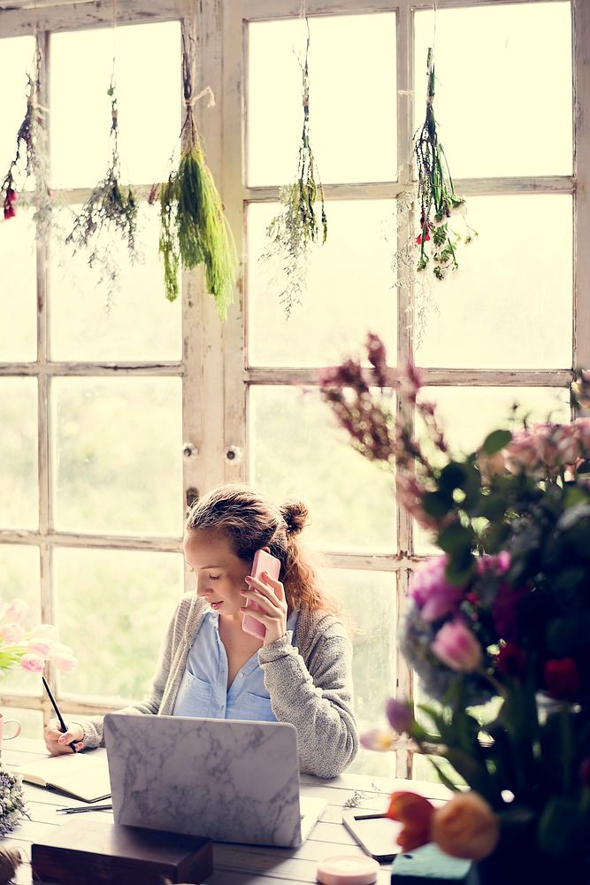 Woman Talking on Mobile Phone in Flower Shop