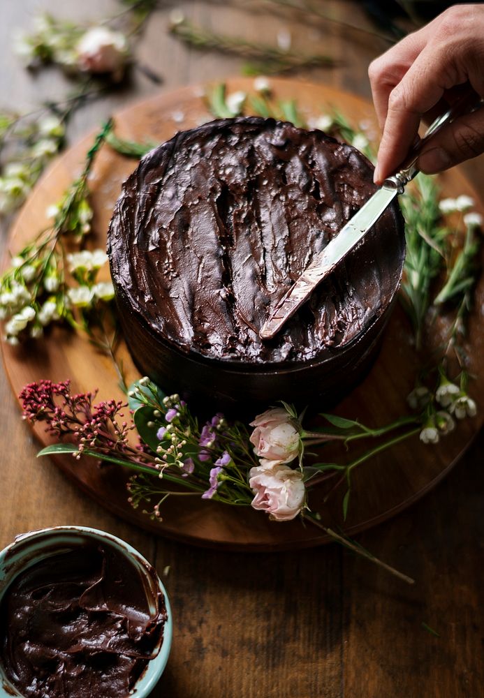 Baker Hand Using Spatula with Chocolate Cake