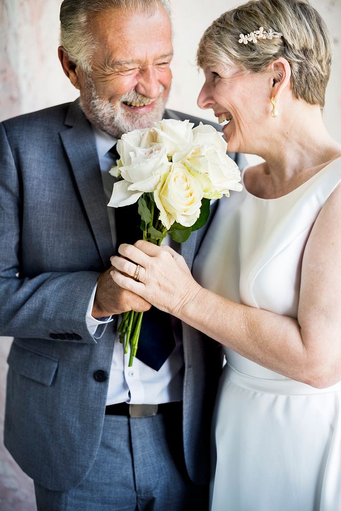 Senior Couple with White Roses Flower Bouqet