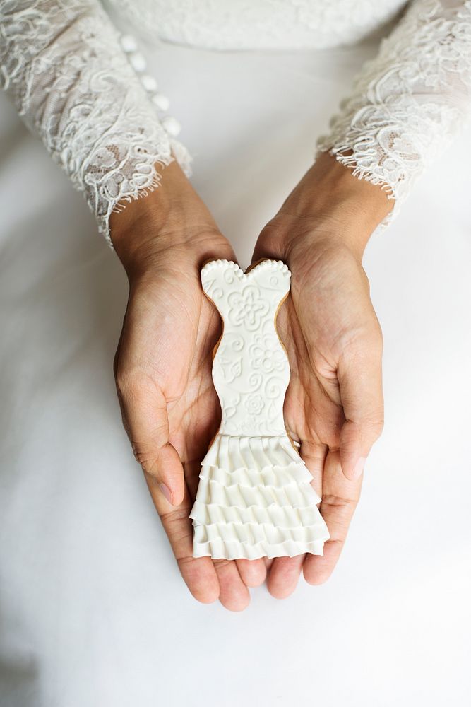 Woman hands holding showing wedding cookies