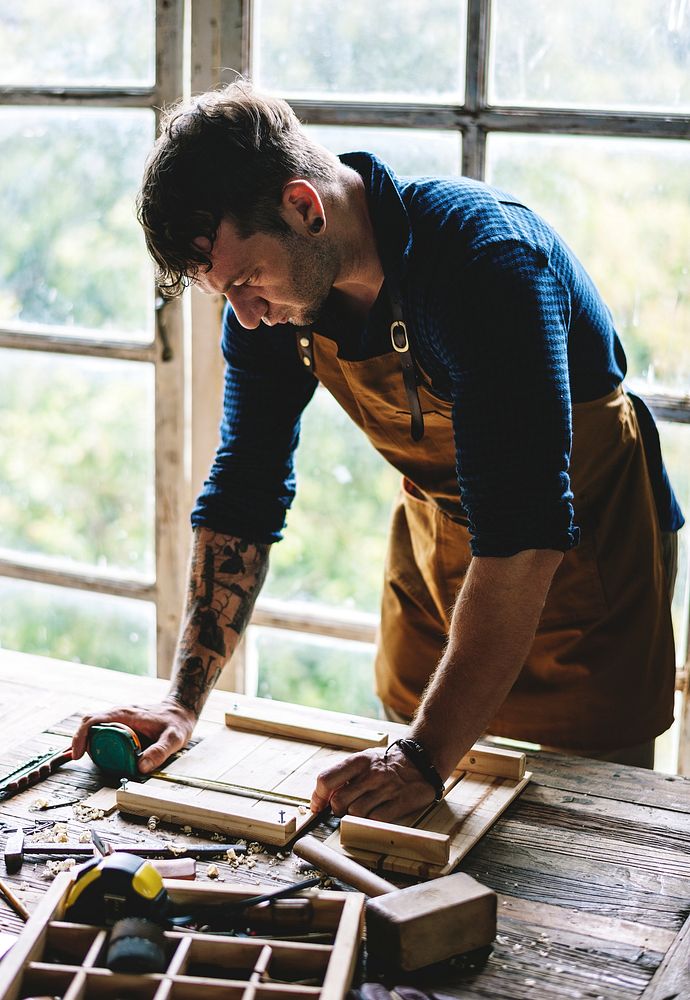Closeup of carpenter man working with tools equipment set