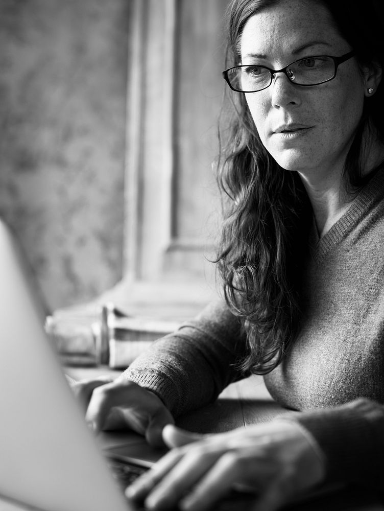 Caucasian woman using computer laptop grayscale