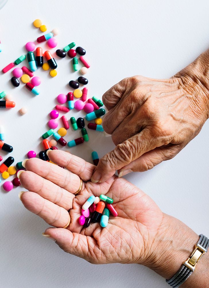 Closeup of hands taking pills health treatment isolated