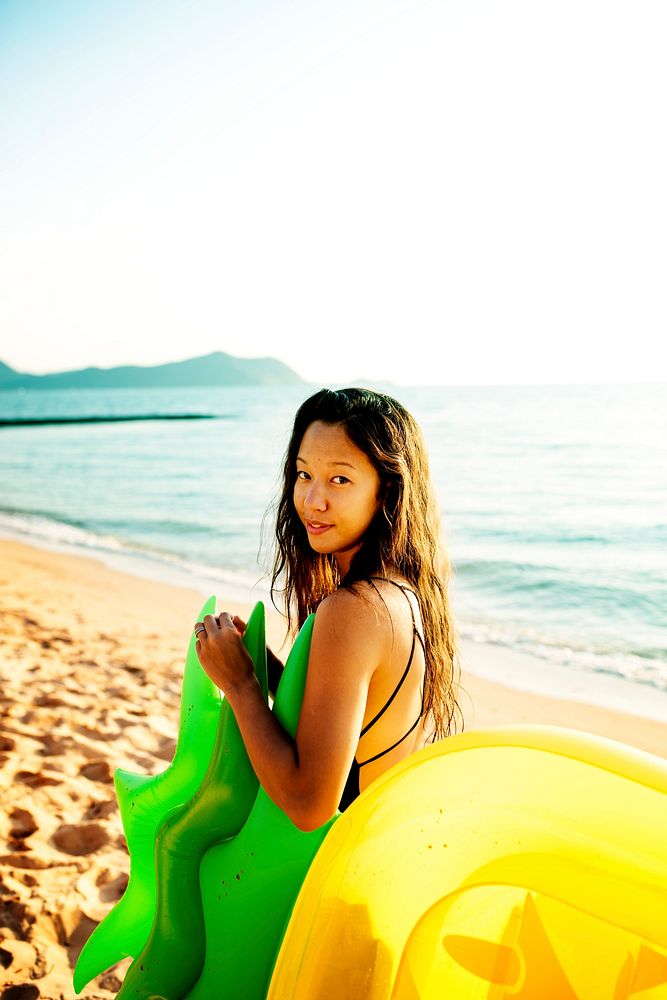 Asian woman with inflatable tube at the beach