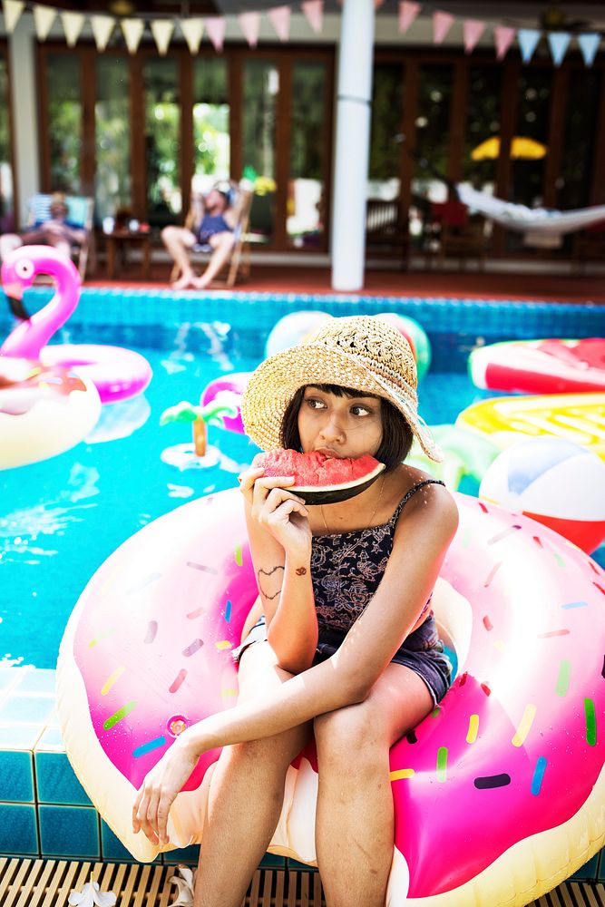 Asian woman eating watermelon tropical summer party on the pool