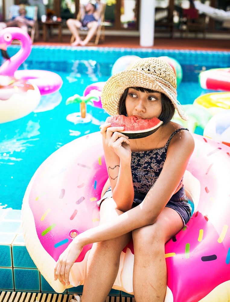 Asian woman eating watermelon tropical summer party on the pool