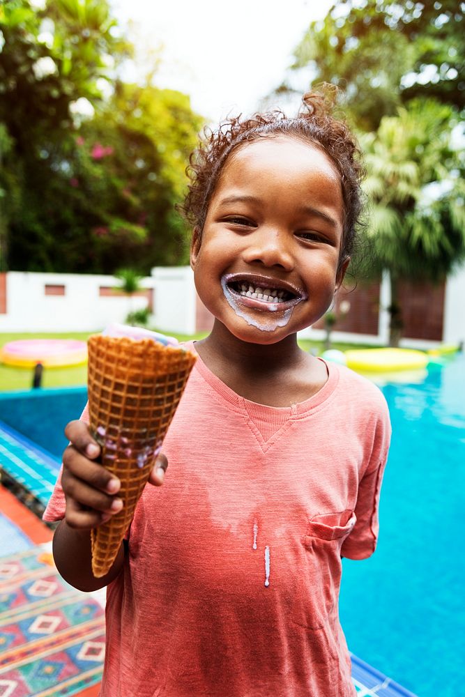 Closeup of african descent girl with ice cream by the pool