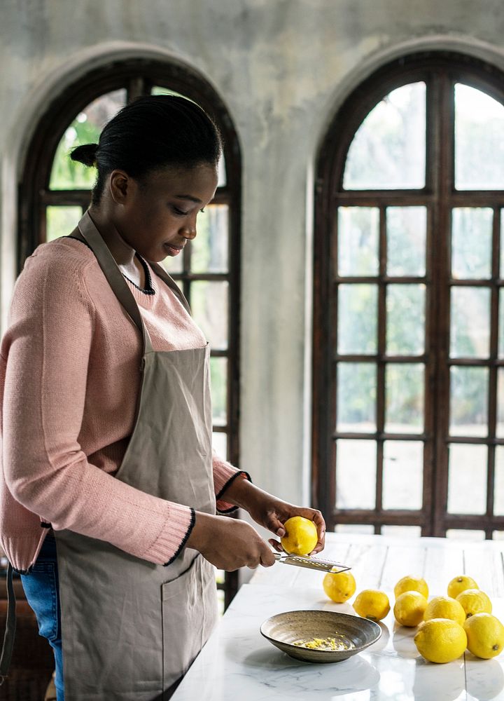 African descent woman grating lemon rind
