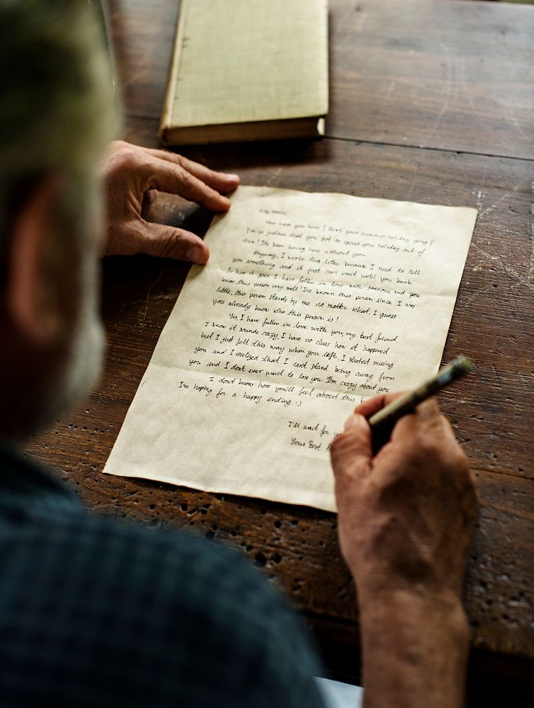 Closeup of senior man writing letter