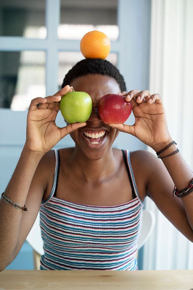 African descent woman with fruits on her face
