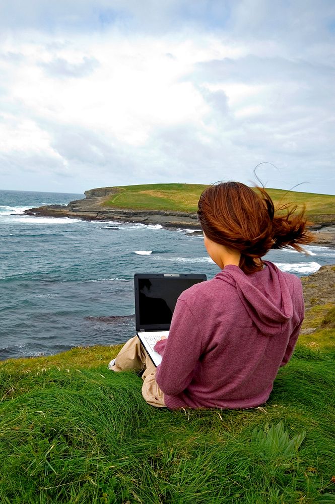 Woman using a computer on the hill