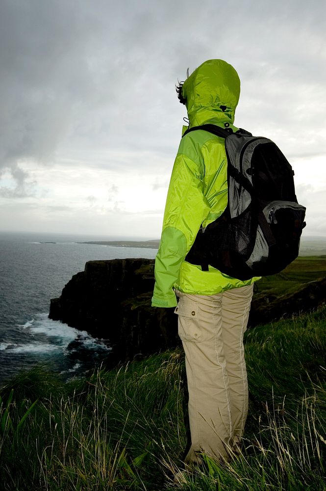 Woman hiking at the Cliffs of Moher