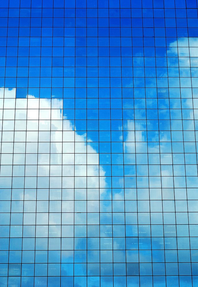 Cloudy sky reflected in a modern office building