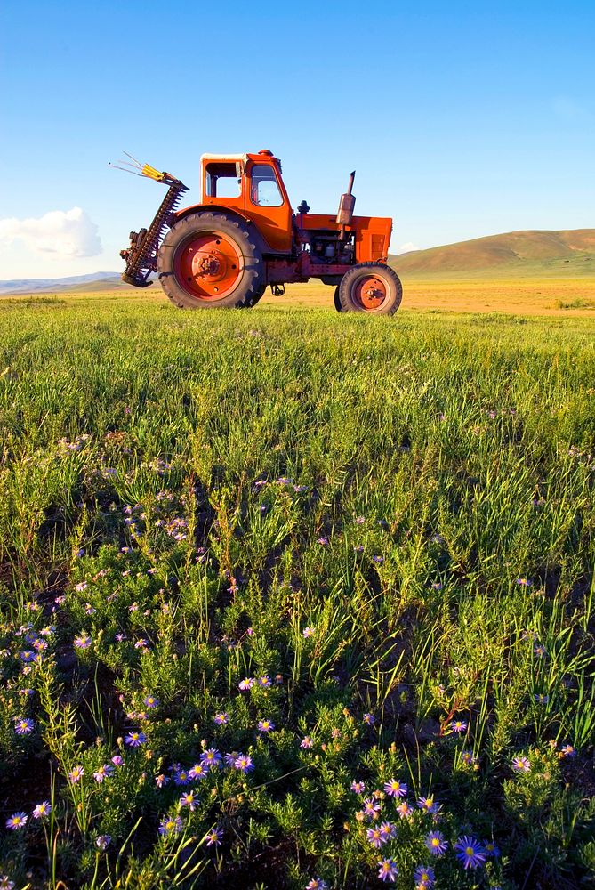 Side view of a tractor in a scenic view.