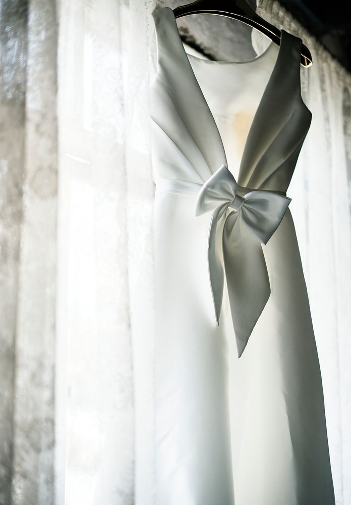White Wedding Dress Hanging by the Window