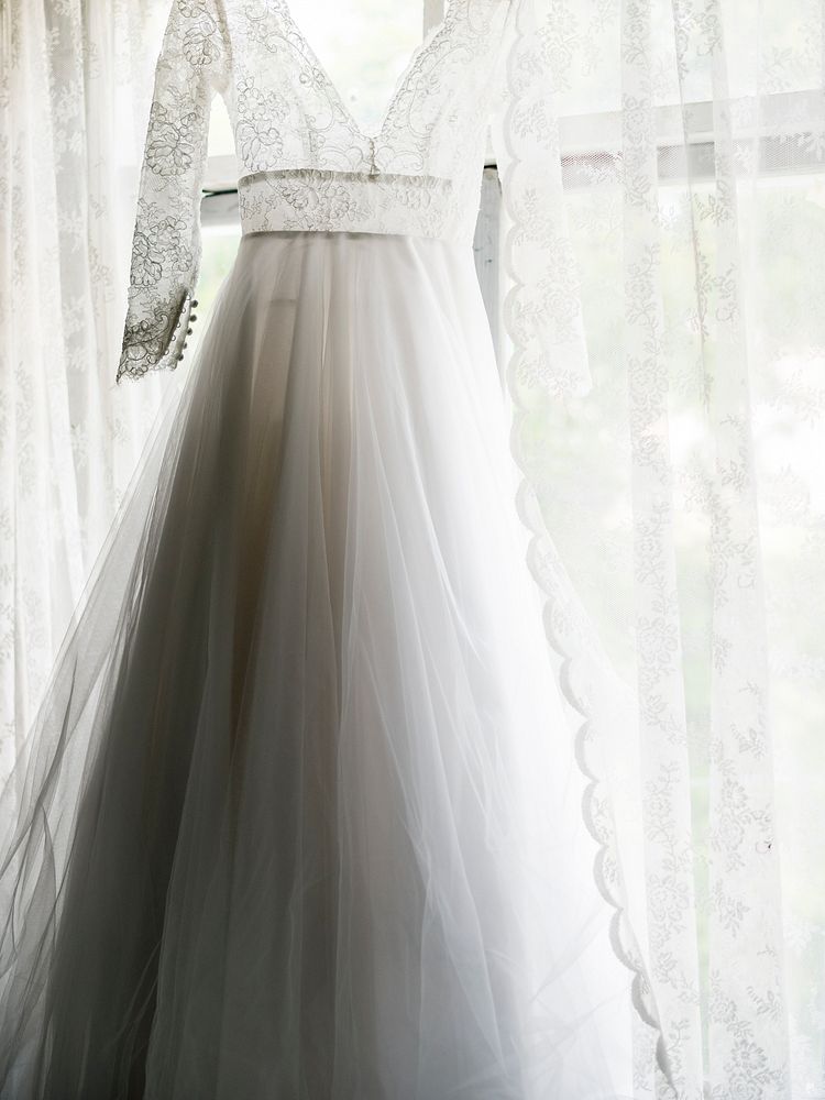 Closeup of White Wedding Dress Hanging by the Window